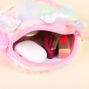 Detail of plush unicorn bag showing rainbow fur texture, zipper, and internal storage space