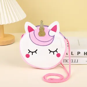 Detail of cute unicorn plush bag featuring gold sequin horn and embroidered eyes
