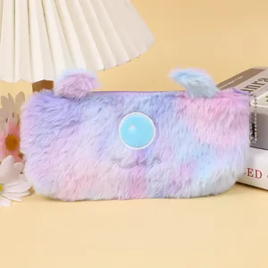 Détail de la trousse en peluche dégradée avec une broderie de monstre mignon à un œil