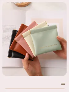 Close-up of portable PU leather squeeze pouches in five colors for small accessories