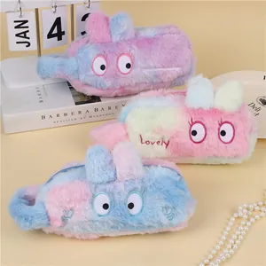 Three gradient plush pencil cases with cute big eye embroidery and soft texture on a desk