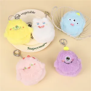 Five colorful plush monster coin purses with metal hooks in yellow, blue, and pink