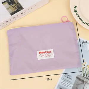 Detail of purple waterproof travel pouch with zipper and dimensions 21cm by 16cm