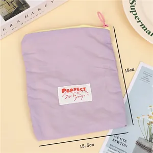 Detail of lavender waterproof makeup bag showing zipper and size of 18cm by 15.5cm
