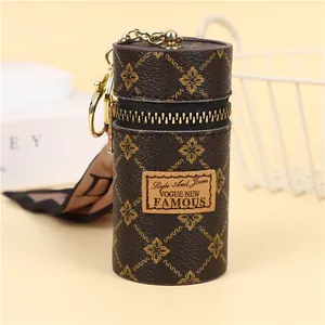 Close-up of vintage monogram bucket mini pouch with gold zipper and keychain detail