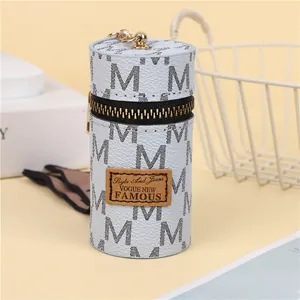 Macro view of blue leather mini bucket pouch with metal hook and monogram patterns