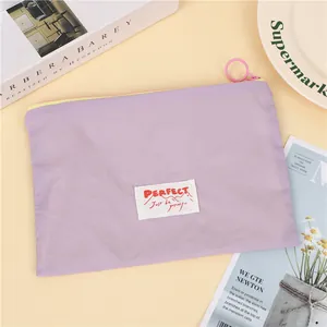 Close-up of lilac waterproof travel makeup bag with zip and decorative accessories