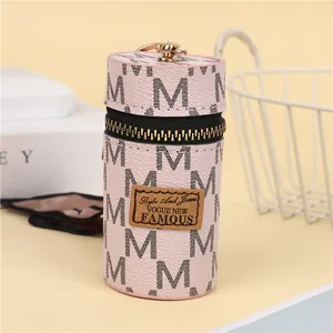 Pink cylinder mini pouch with black M letter print, golden zipper and metal keychain hook