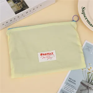 Large capacity yellow macaron travel makeup bag with waterproof fabric and blue zipper