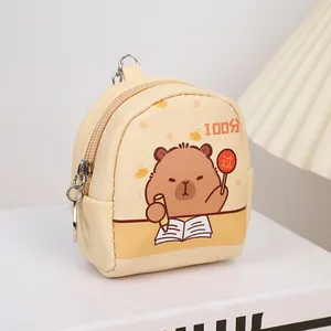 Detail of cream mini backpack coin purse featuring cartoon bear and metal zipper