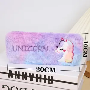 Detail of plush unicorn pencil case showing rainbow faux fur and embroidered logo