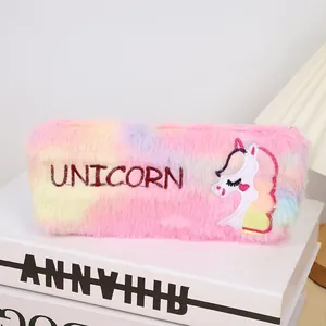 Detail of plush rainbow pencil case with unicorn embroidery on a soft scene background