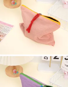 Close-up of contrast checkered canvas pouches with durable colorful zippers and pullers