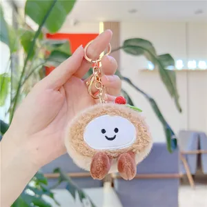 Close-up of plush matcha strawberry cake keychain with embroidered face and gold clasp