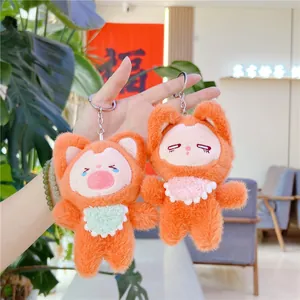 Plush orange fox keychain toys with silver metal rings held in hand indoors