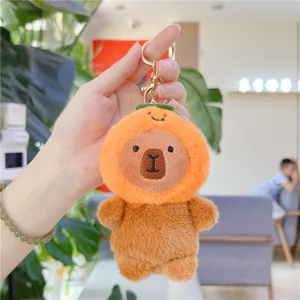 Cute Capybara plush keychain wearing an orange hat with a golden metal clasp and ring