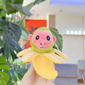 Close-up of creative banana monkey plush keychain with soft yellow peel and green head