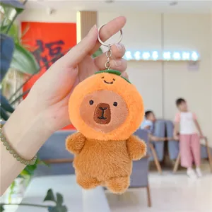 Close-up of capybara plush keychain wearing an orange hat with silver metal keyring