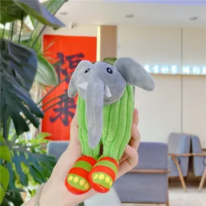 Detail of elephant plush keychain with green striped fabric body and colorful shoes