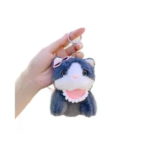 Cute plush cat keychain with pink heart sunglasses and lace collar on white background