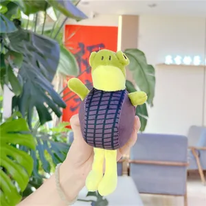 Close-up of a purple and green plush doll keychain with net texture and soft limbs
