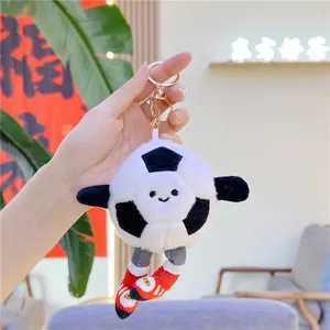 Cute soccer plush keychain with black and white football character in red sneakers