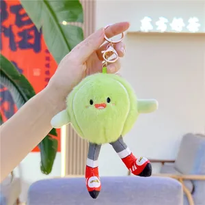 Close-up of fluffy lime green plush ball keychain with cute sports shoes and gold clasp
