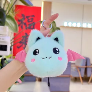 Close-up of light blue plush bat keychain with pink wings and silver metal keyring