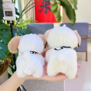 Detail showing plush dog keychains with soft white fur and stylish black collars