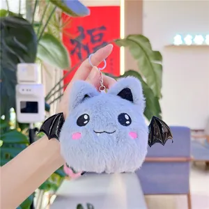 Close-up of greyish-purple plush bat keychain with shiny wings and embroidery details