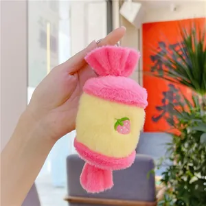 Detail of pink and yellow candy plush keychain with strawberry embroidery and silver ring