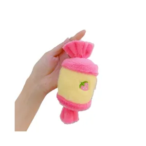 Pink and yellow plush candy-shaped charm with strawberry embroidery and hanging ring