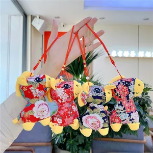 Detail of four Chinese zodiac horse plush pendants with floral embroidery and hanging cords