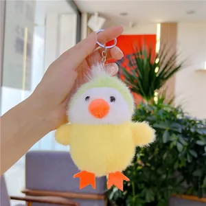 Close-up of yellow plush chicken keychain charm with metal ring and fluffy texture