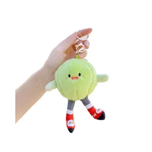 Cute green vegetable plush keychain with sneakers and gold metal clip on white background