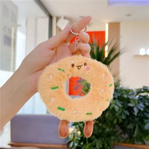 Close-up of cute plush donut keychain with colorful embroidery and metal ring