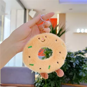 Macro detail of plush donut keychain with embroidery and silver metal ring