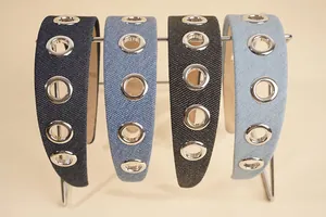 Detail of wide denim headbands featuring decorative silver metal eyelets and non-slip lining