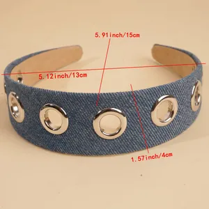 Detail of denim headband with metal grommets showing size measurements and texture