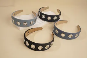 Detail view of denim wide headbands with silver eyelet studs in blue and navy