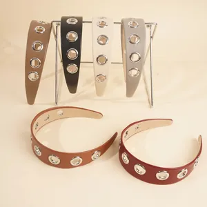 Close-up of PU leather wide headbands with metal eyelets in six various colors