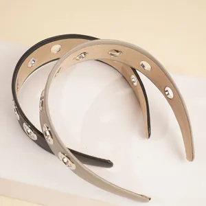 Detailed close-up of wide PU leather headbands with silver metal grommets and anti-slip lining