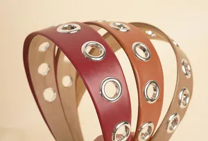 Macro detail of PU leather wide headbands with decorative silver metal eyelets in multiple colors