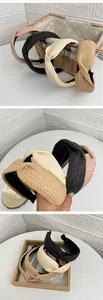 Detailed view of woven raffia bow headbands in pink, black, beige and light brown