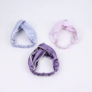 Three purple satin cross-knot headbands with white piping detail and elastic back