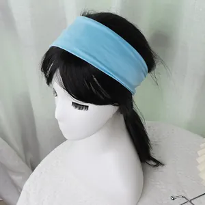 Detail of light blue wide elastic sports headband on model showing soft breathable fabric