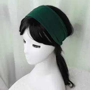 Detail of dark green breathable elastic sports headband on a model head stand