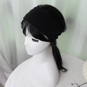 Detailed view of black elastic sports headband showing the wide stretchable fabric texture