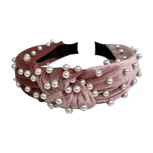 Pink velvet knotted headband with white faux pearls and elegant striped texture