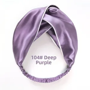 Detail of dark purple silk headband with elegant white contrast piping and twisted knot